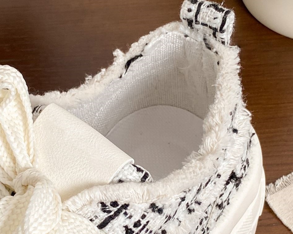 details of white canvas trainers